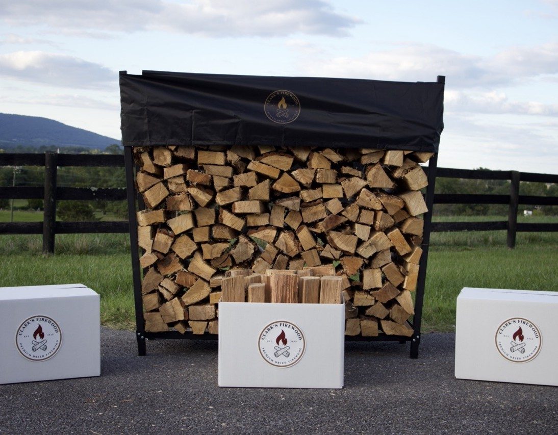 Covered firewood rack with branded firewood boxes in the Virginia countryside